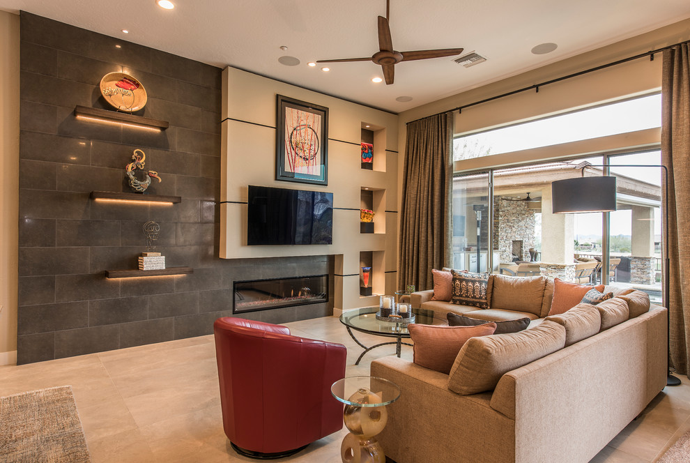 Large contemporary enclosed living room in Phoenix with beige walls, a ribbon fireplace, a tile fireplace surround, a wall-mounted tv, beige floor and porcelain floors.