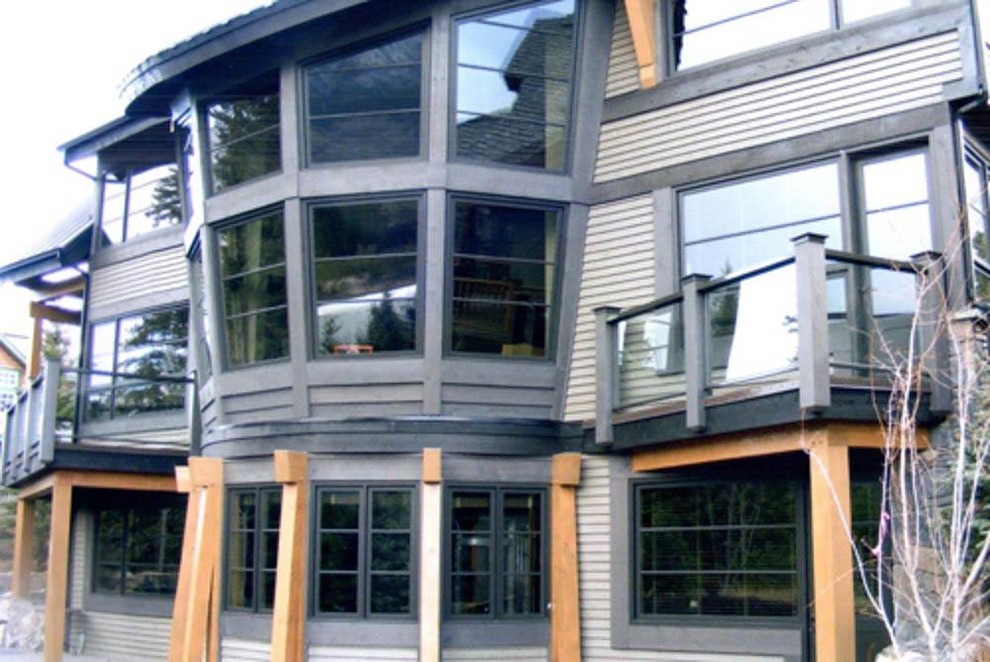 Huge mountain style backyard deck photo in Calgary