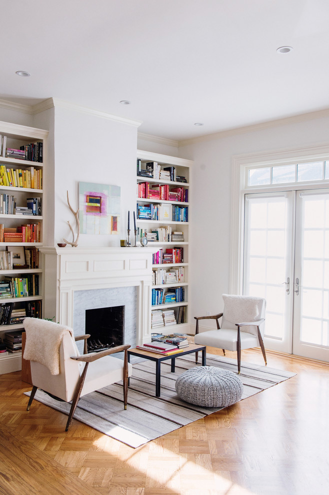 Inspiration for a scandinavian living room in San Francisco with white walls, light hardwood floors, a standard fireplace and a library.