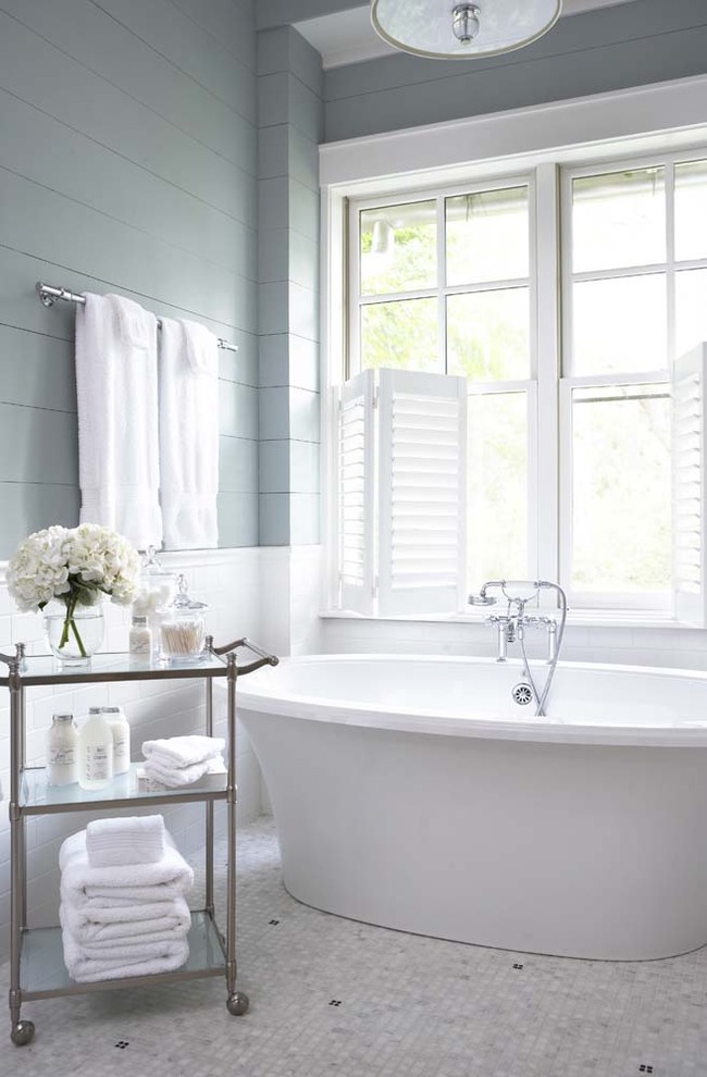 Design ideas for a large traditional master bathroom in Charleston with a freestanding tub, subway tile, white tile, blue walls and mosaic tile floors.