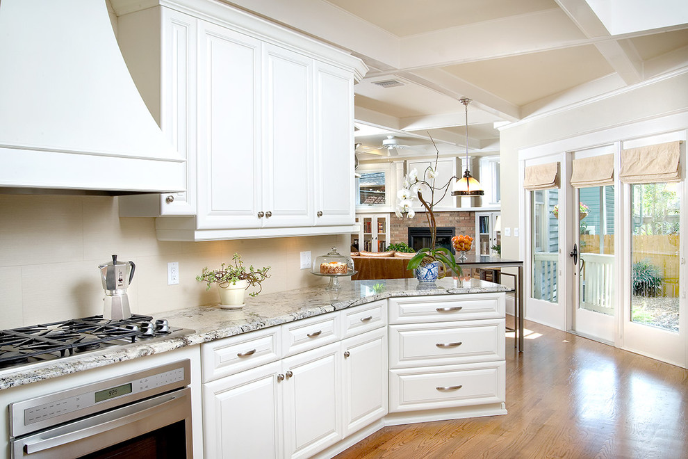 Design ideas for a traditional kitchen in Tampa with white cabinets and granite benchtops.