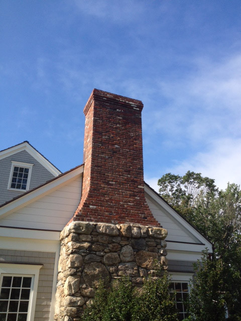 Replace brick chimney with cobble stone so that landscape walls match.   Peter Atkins and Associates/