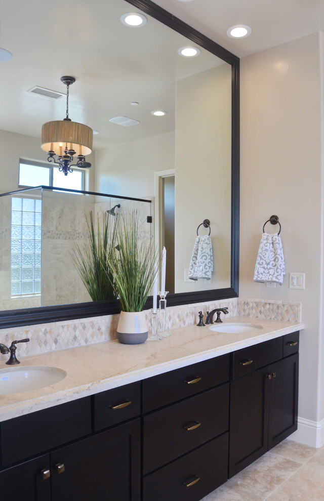 Inspiration for a mid-sized transitional master bathroom in Other with shaker cabinets, dark wood cabinets, a drop-in tub, a corner shower, beige tile, ceramic tile, beige walls, travertine floors, an undermount sink and marble benchtops.