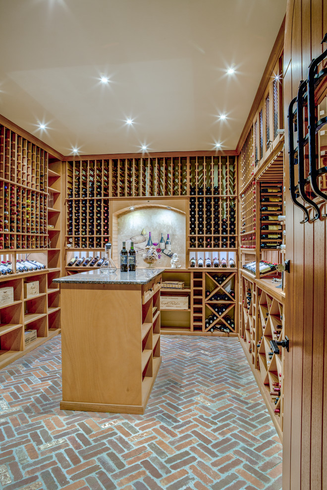Design ideas for a large traditional wine cellar in Boston with brick floors, storage racks and brown floor.