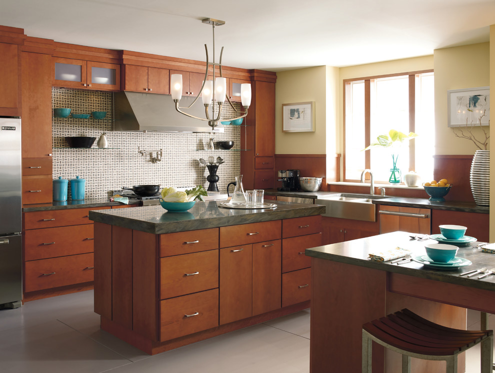This is an example of a modern l-shaped kitchen in Other with medium wood cabinets, stainless steel appliances, multiple islands, beige floor and green benchtop.
