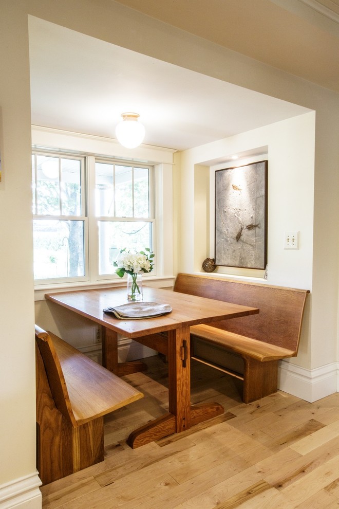 Inspiration for a mid-sized country dining room in Chicago with light hardwood floors.