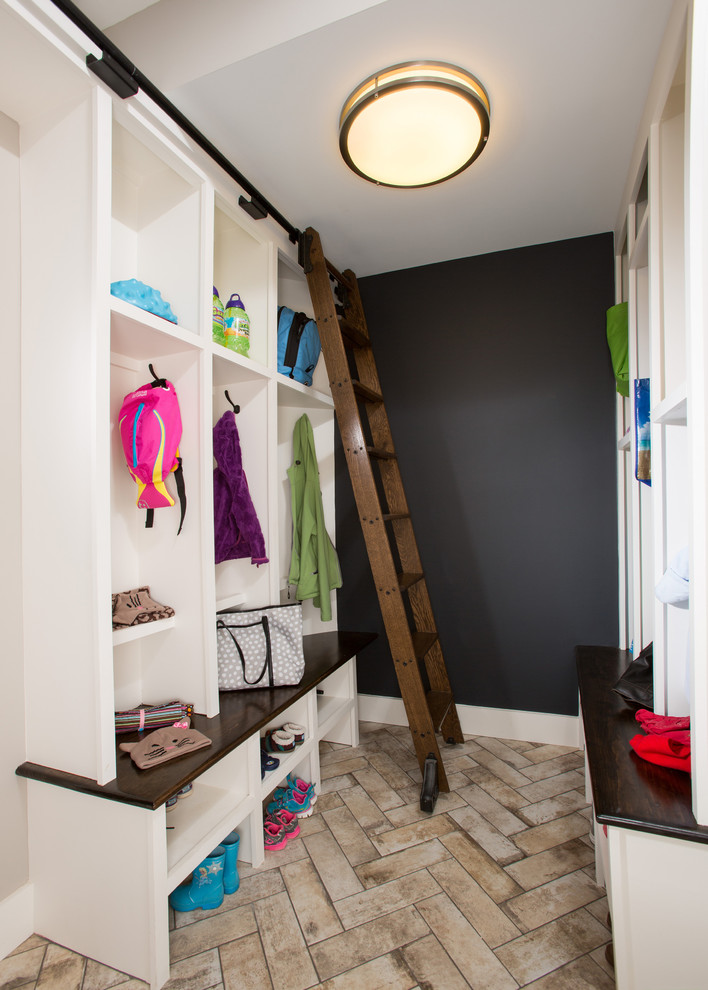 Design ideas for a transitional mudroom in DC Metro with black walls and beige floor.