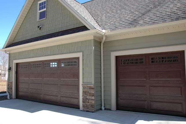This is an example of an expansive arts and crafts attached three-car garage in Cleveland.