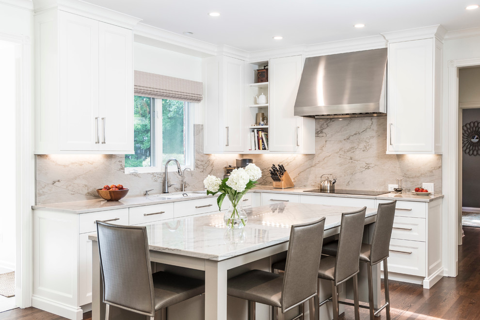 Design ideas for a transitional l-shaped kitchen in Indianapolis with recessed-panel cabinets, white cabinets, marble benchtops, stone slab splashback, medium hardwood floors, an undermount sink, beige splashback and with island.