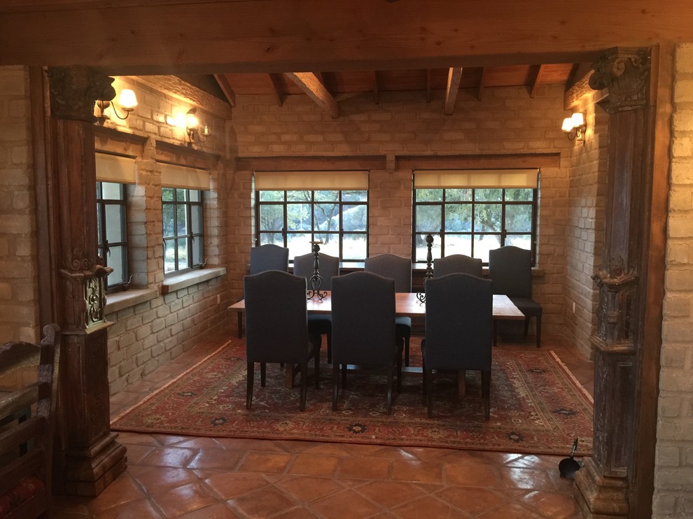 Mid-sized mediterranean open plan dining in Phoenix with grey walls, terra-cotta floors and brown floor.