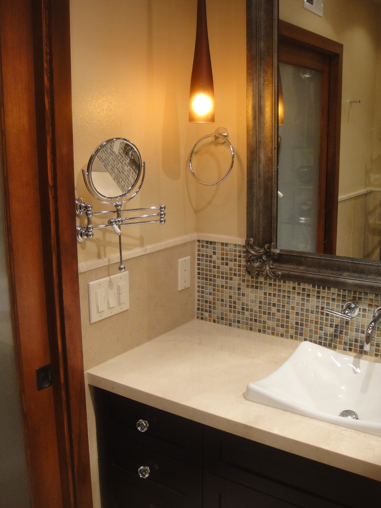 This is an example of a small modern 3/4 bathroom in San Diego with shaker cabinets, dark wood cabinets, a curbless shower, a two-piece toilet, blue tile, matchstick tile, beige walls, porcelain floors, a drop-in sink and solid surface benchtops.