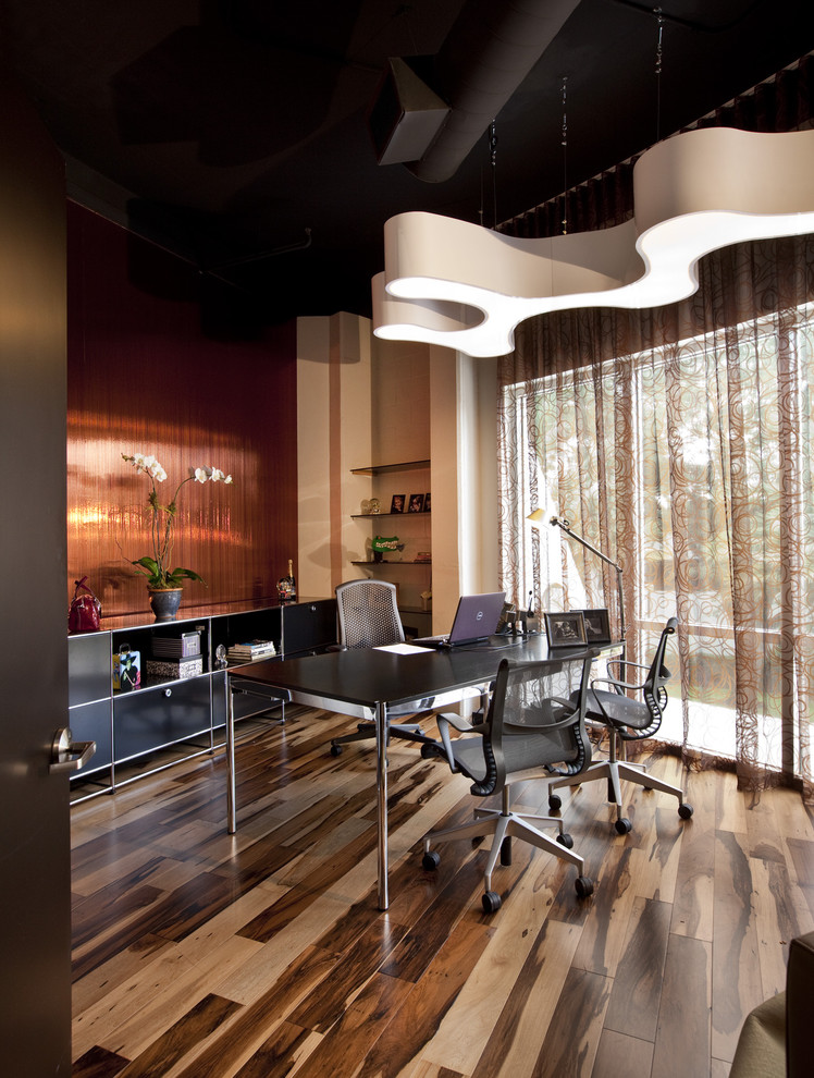 Inspiration for a contemporary home office in Orlando with dark hardwood floors, a freestanding desk and brown floor.