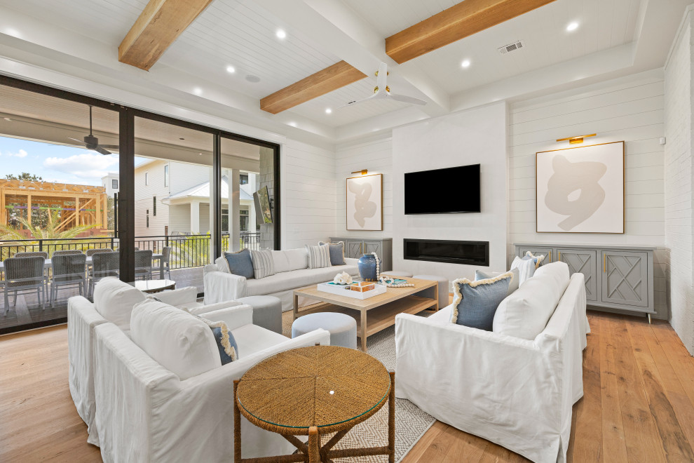 Foto di un soggiorno stile marino con pareti bianche, parquet chiaro, TV a parete e pareti in perlinato