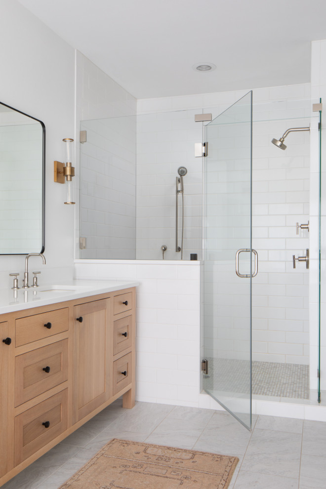 Design ideas for a large transitional master bathroom in Milwaukee with shaker cabinets, brown cabinets, an alcove shower, white tile, ceramic tile, white walls, ceramic floors, an undermount sink, engineered quartz benchtops, grey floor, a hinged shower door, white benchtops, a double vanity and a freestanding vanity.