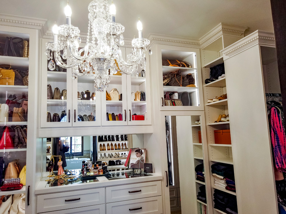 This is an example of a large traditional women's storage and wardrobe in Houston with shaker cabinets, white cabinets and carpet.