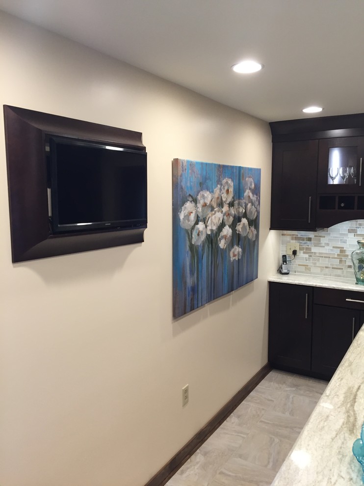 Example of a transitional ceramic tile kitchen design with a single-bowl sink, dark wood cabinets, multicolored backsplash, mosaic tile backsplash, stainless steel appliances and an island