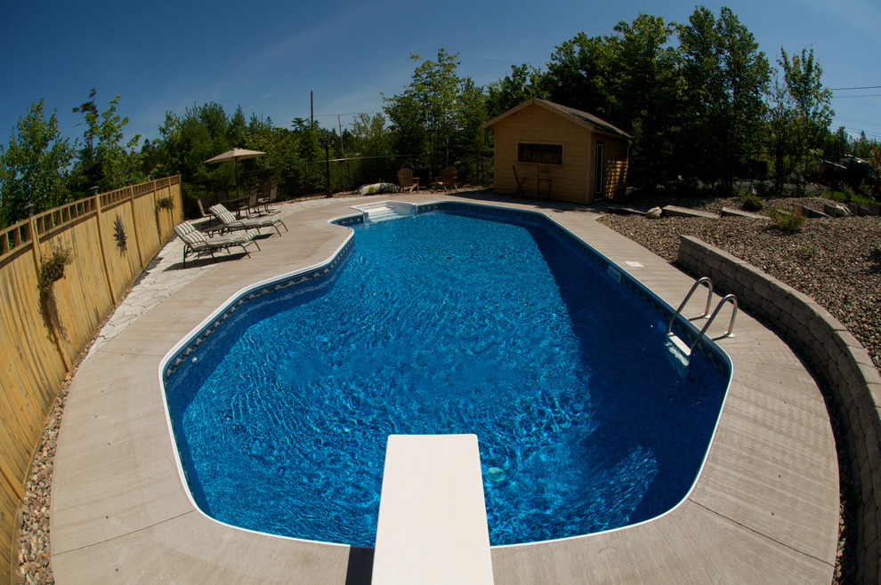 Design ideas for a large traditional backyard pool in Other with concrete slab.