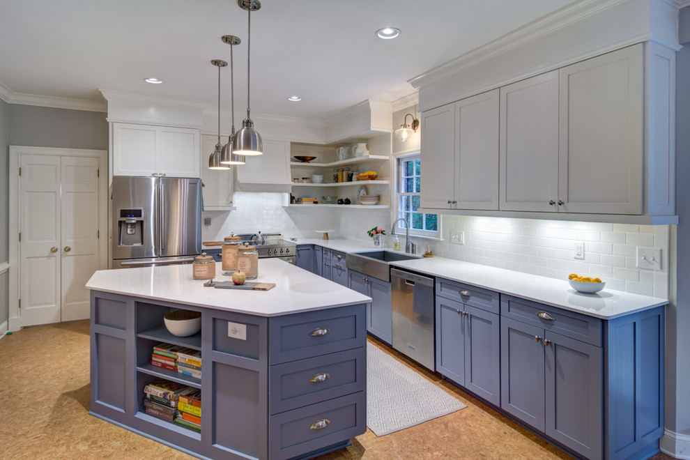 This is an example of a mid-sized transitional l-shaped eat-in kitchen in Atlanta with a farmhouse sink, shaker cabinets, white cabinets, quartzite benchtops, white splashback, subway tile splashback, stainless steel appliances, cork floors, with island and brown floor.