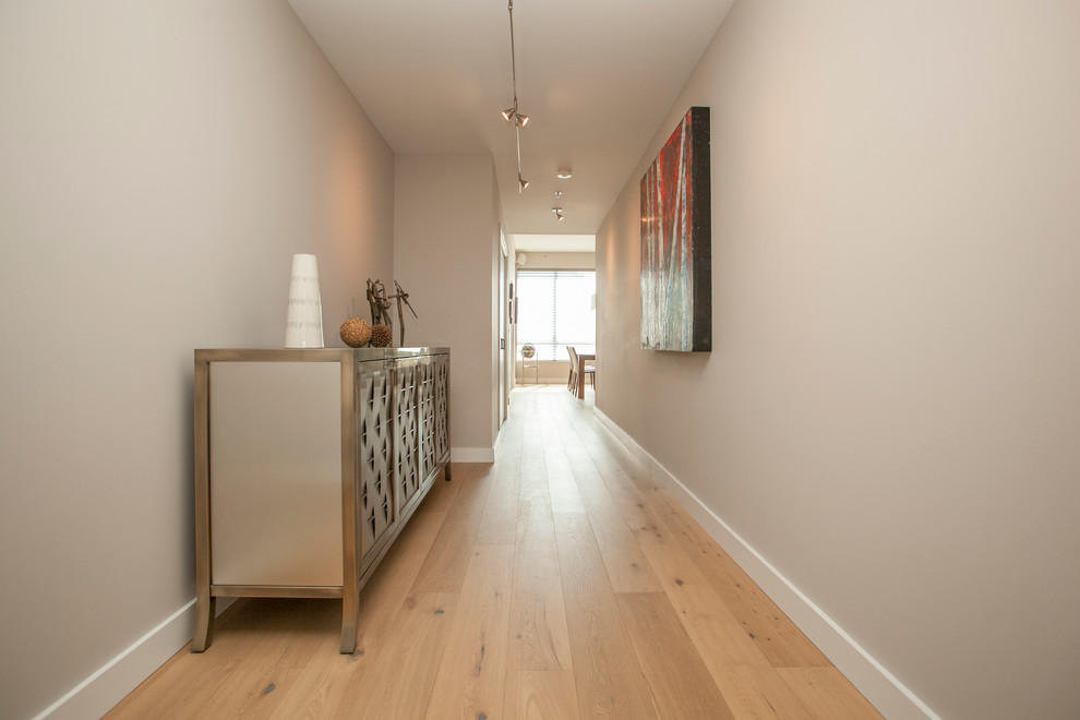 Mid-sized contemporary hallway in Portland with grey walls and light hardwood floors.