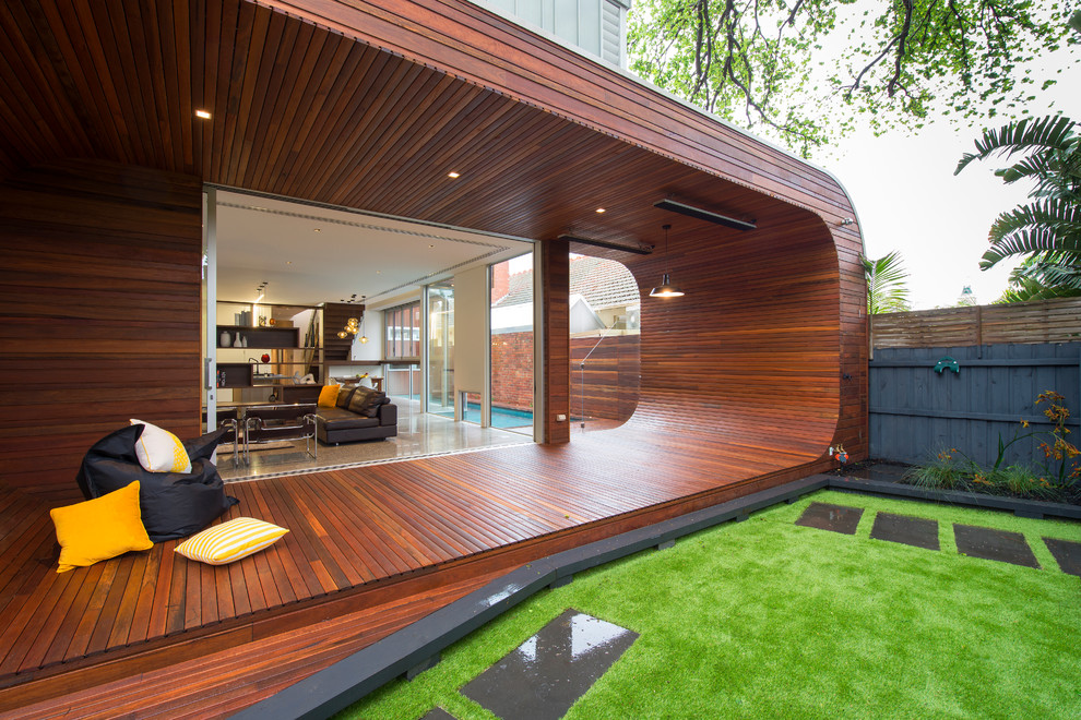 Inspiration for a mid-sized contemporary backyard deck in Melbourne with a roof extension.