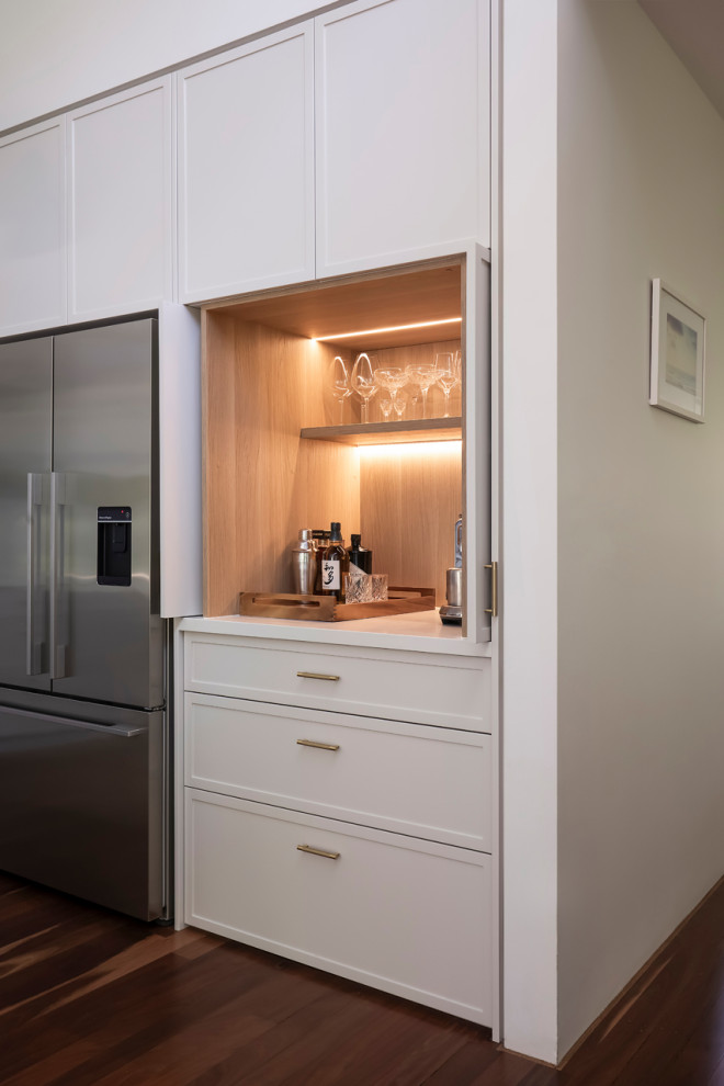 Photo of a small contemporary single-wall wet bar in Sydney with shaker cabinets, light wood cabinets, quartz benchtops, multi-coloured splashback, engineered quartz splashback and white benchtop.