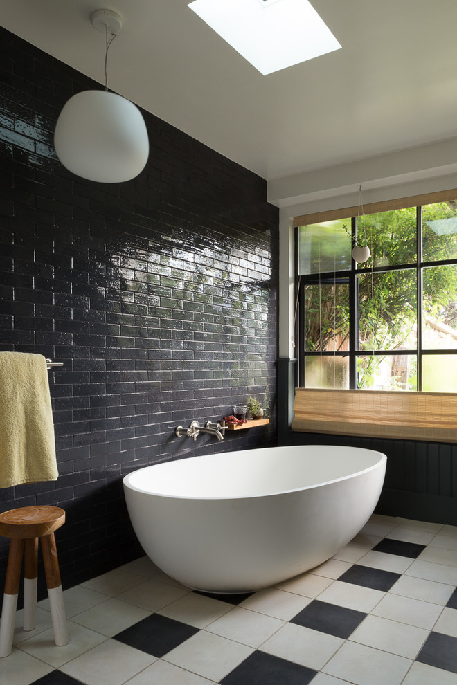 Design ideas for a mid-sized eclectic master bathroom in San Francisco with a freestanding tub, black tile, subway tile, an alcove shower, white walls and porcelain floors.