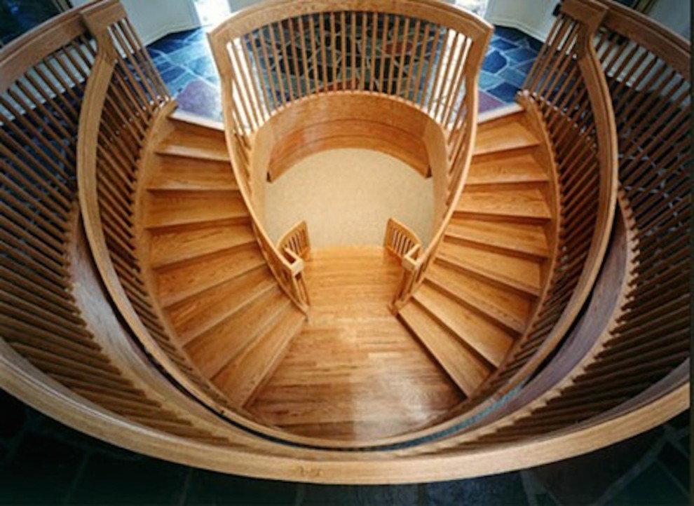 Inspiration for a huge wooden curved staircase remodel with wooden risers