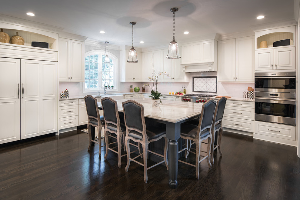 Inspiration for a large traditional l-shaped eat-in kitchen in Minneapolis with a farmhouse sink, beaded inset cabinets, white cabinets, white splashback, subway tile splashback, stainless steel appliances, dark hardwood floors and with island.
