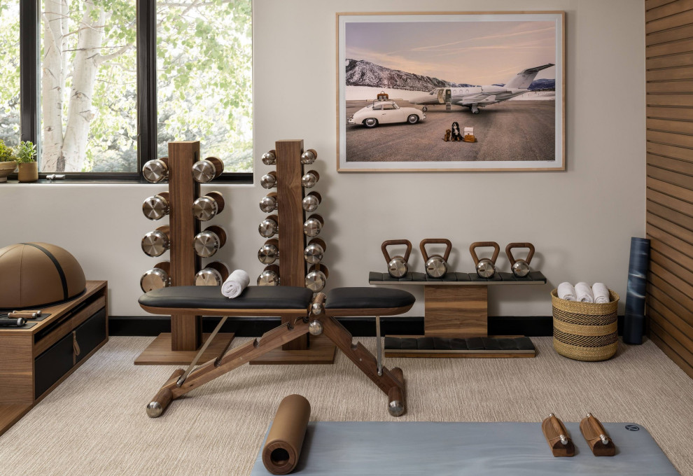 This is an example of a medium sized traditional home weight room in Denver with beige walls and carpet.