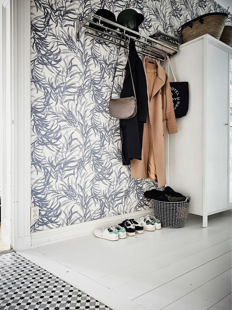 Design ideas for a scandinavian entryway in Gothenburg with blue walls and painted wood floors.