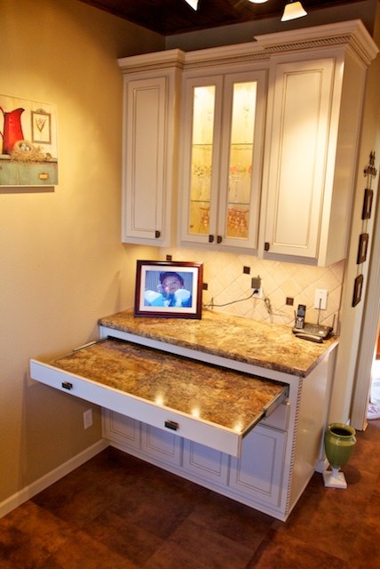 Inspiration for a small l-shaped eat-in kitchen remodel with a drop-in sink, raised-panel cabinets, white cabinets, laminate countertops, white backsplash, stone tile backsplash and black appliances
