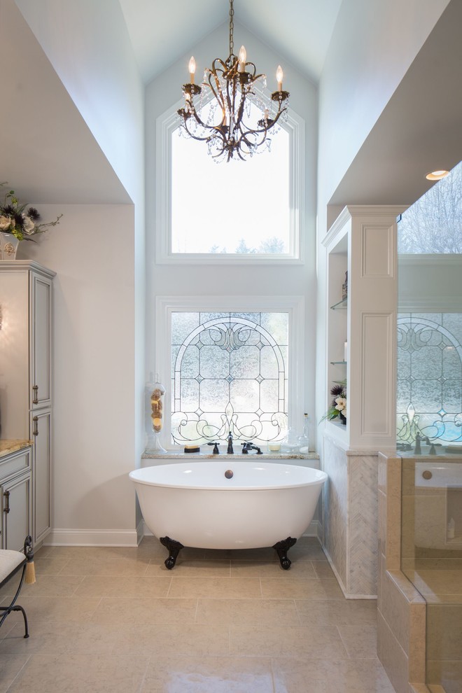This is an example of a mid-sized traditional master bathroom in Atlanta with raised-panel cabinets, a claw-foot tub, a corner shower, beige tile, stone tile, grey walls, porcelain floors, an undermount sink and granite benchtops.