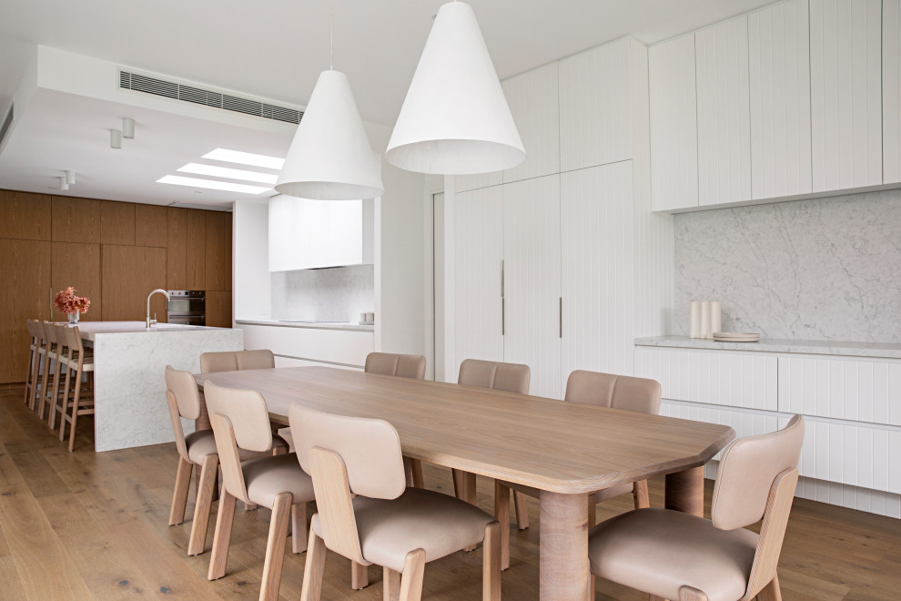 Design ideas for a contemporary open plan dining in Melbourne with white walls, medium hardwood floors and brown floor.