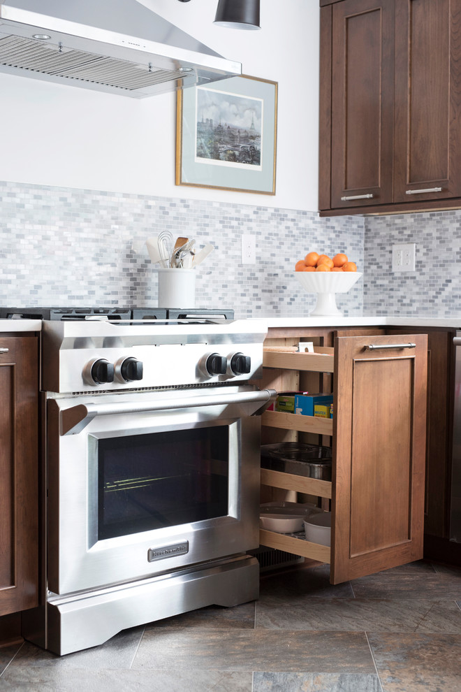 Inspiration for a mid-sized transitional u-shaped vinyl floor and multicolored floor kitchen remodel with an undermount sink, shaker cabinets, brown cabinets, quartz countertops, gray backsplash, marble backsplash, stainless steel appliances, no island and white countertops