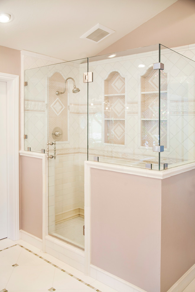 Large traditional master bathroom in San Francisco with beaded inset cabinets, dark wood cabinets, a freestanding tub, an open shower, a one-piece toilet, white tile, stone tile, pink walls, travertine floors, an undermount sink, marble benchtops and a hinged shower door.