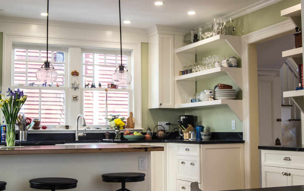 This is an example of a transitional eat-in kitchen in Boston with a double-bowl sink, recessed-panel cabinets, white cabinets, wood benchtops, stainless steel appliances, medium hardwood floors and with island.
