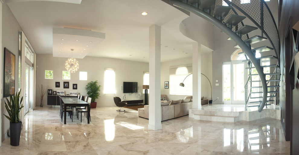 This is an example of a large contemporary open concept living room in Miami with white walls, marble floors and a wall-mounted tv.