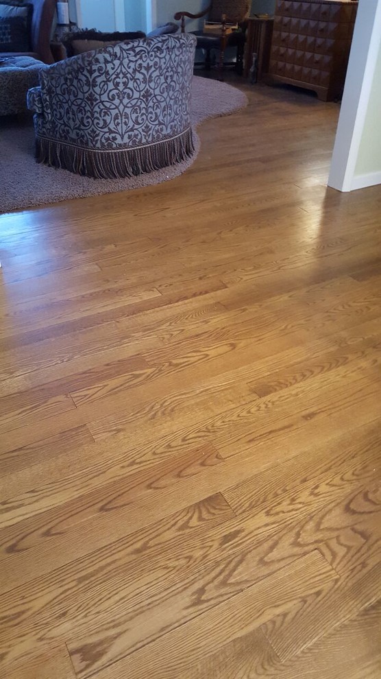Large country u-shaped medium tone wood floor kitchen photo in Milwaukee with white cabinets and a peninsula