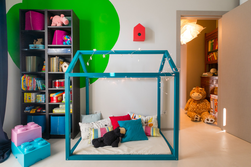 Design ideas for a contemporary gender-neutral kids' playroom for kids 4-10 years old in Rome with multi-coloured walls and porcelain floors.