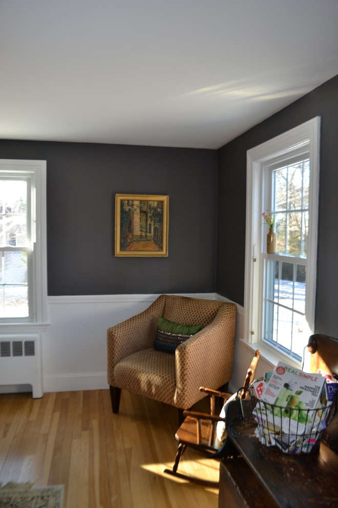 Design ideas for a mid-sized traditional enclosed family room in Boston with a library, grey walls, light hardwood floors and no tv.