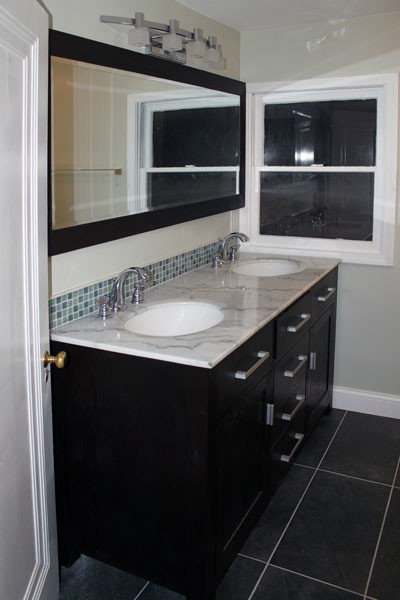 Transitional bathroom in Columbus with an undermount sink, recessed-panel cabinets, black cabinets and marble benchtops.