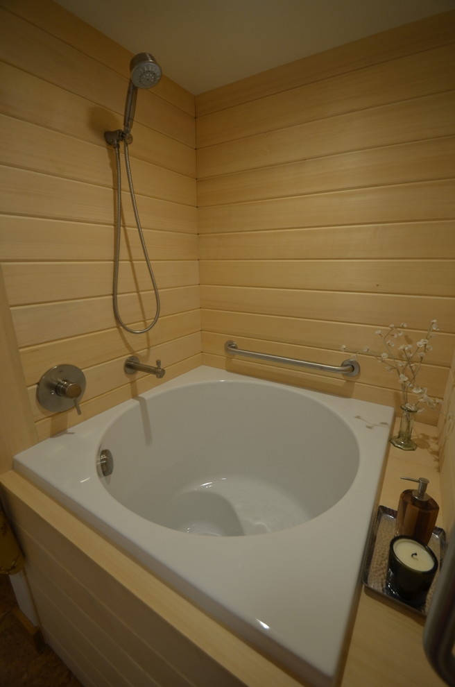 This is an example of an asian master bathroom in San Francisco with flat-panel cabinets, grey cabinets, a japanese tub, a one-piece toilet and beige walls.