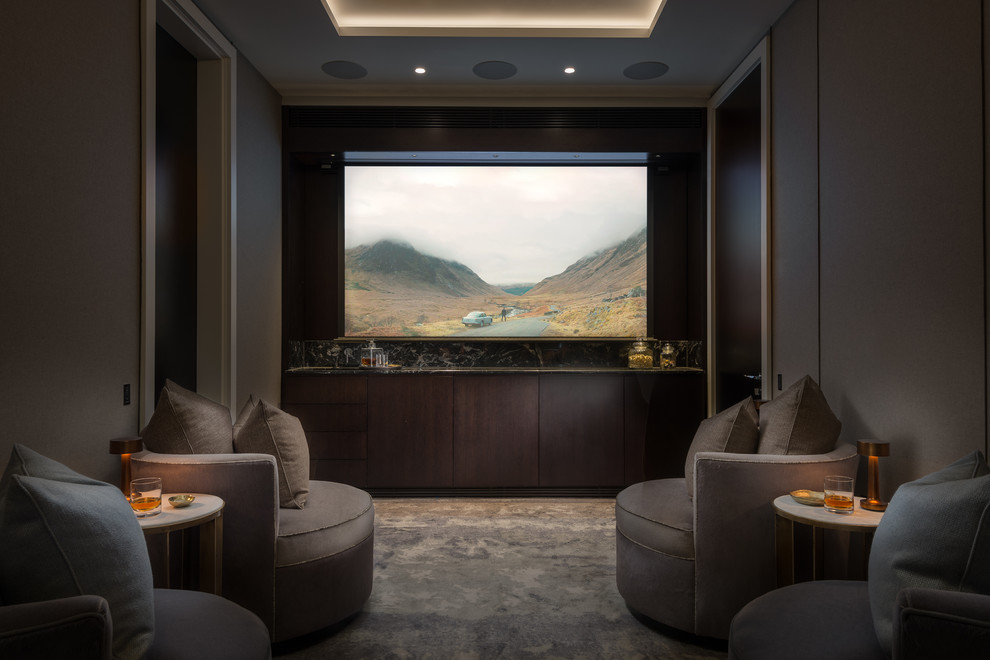 Mid-sized contemporary enclosed home theatre in London with grey walls, carpet, a projector screen and grey floor.