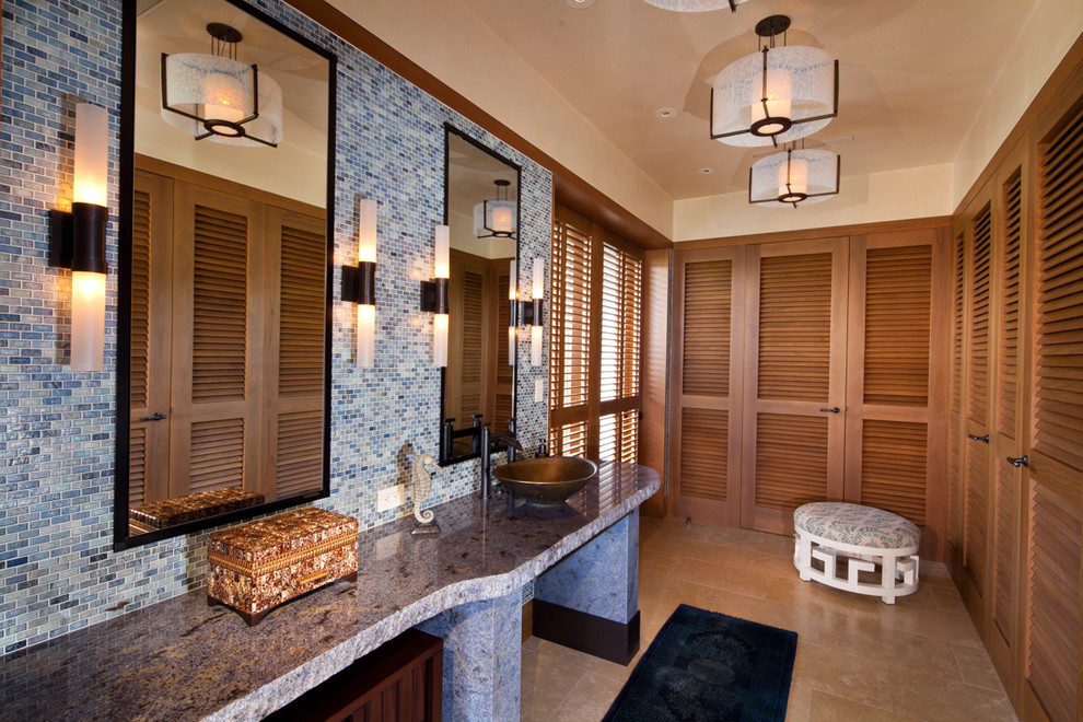 This is an example of a tropical bathroom in Other with a vessel sink, louvered cabinets, medium wood cabinets, blue tile, mosaic tile and beige walls.