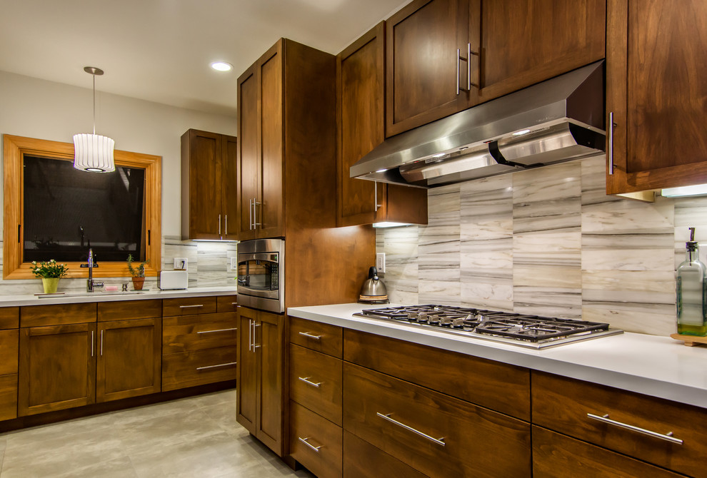 Inspiration for a transitional kitchen in San Francisco with shaker cabinets, dark wood cabinets, white splashback, stainless steel appliances and stone tile splashback.