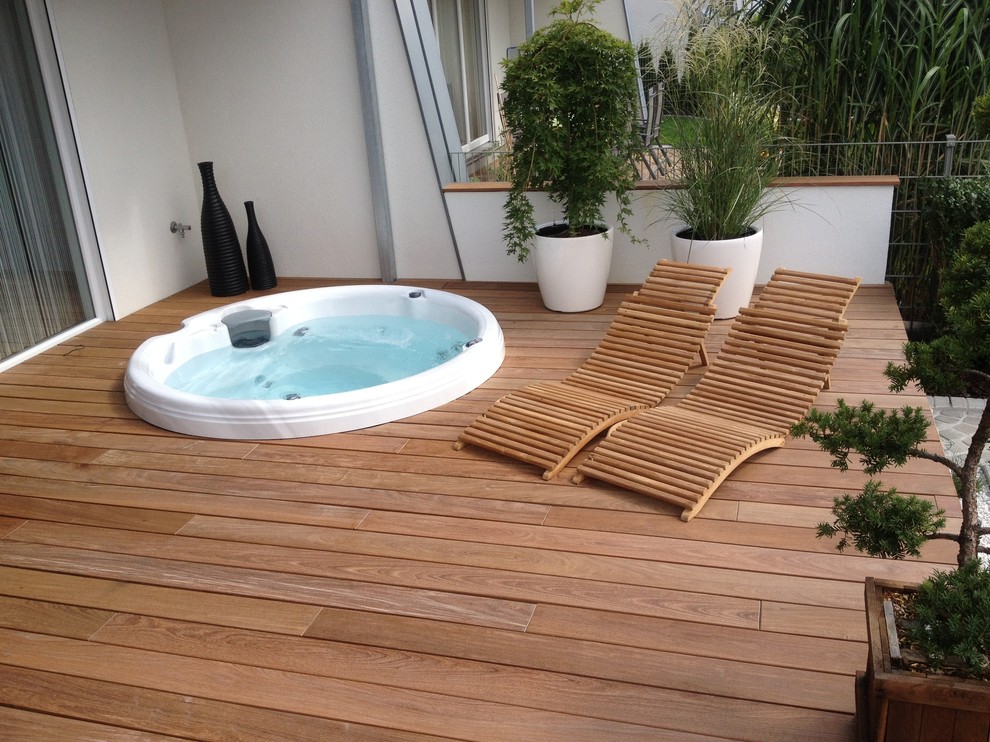 This is an example of a small contemporary courtyard round aboveground pool in Los Angeles with a hot tub and decking.