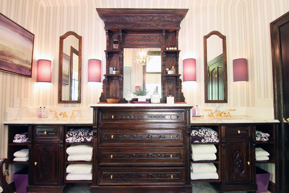 Inspiration for a large traditional master bathroom in New York with an undermount sink, furniture-like cabinets, dark wood cabinets, marble benchtops, a drop-in tub, a corner shower, a one-piece toilet, multi-coloured walls and marble floors.