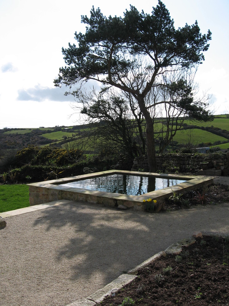 This is an example of a traditional pool in Cornwall with a hot tub and gravel.