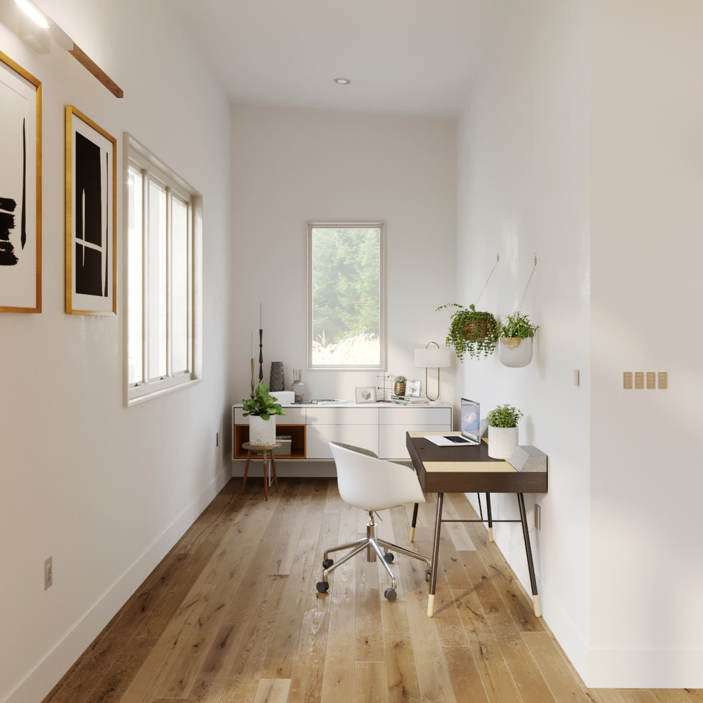 This is an example of a small scandinavian study room in San Francisco with a freestanding desk, white walls, light hardwood floors, no fireplace and brown floor.