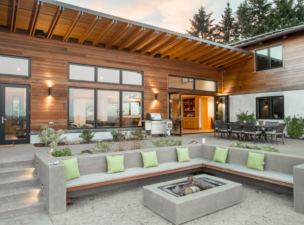 Contemporary backyard patio in Portland with concrete slab and no cover.